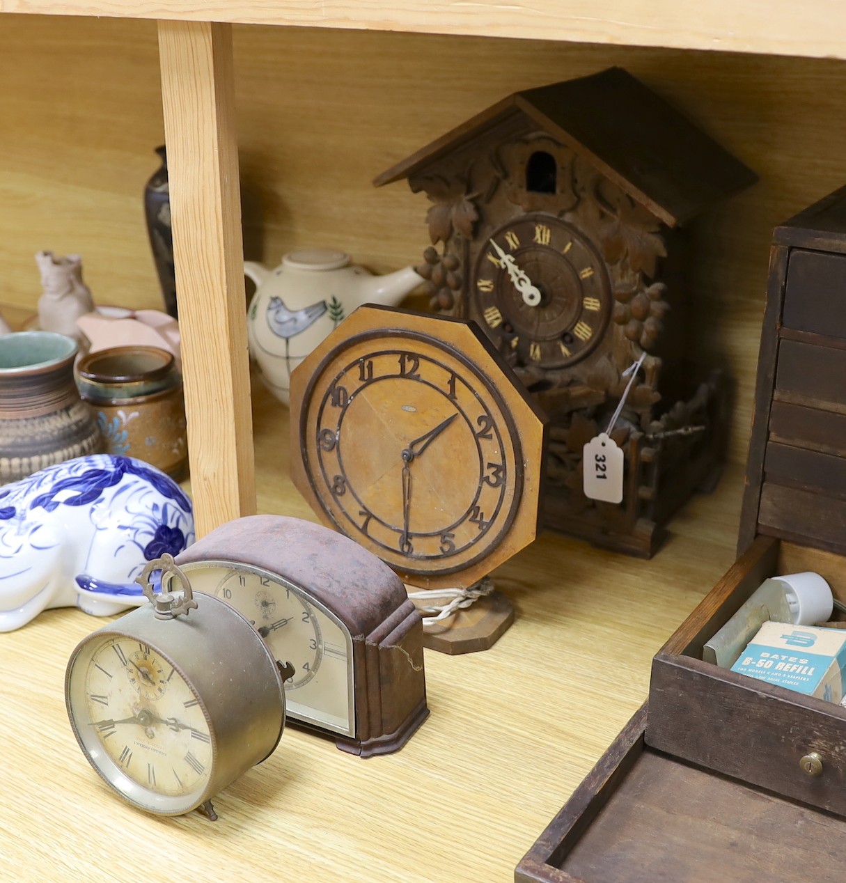 A Black Forest cuckoo clock, together with another octagonal faced timepiece, a Bakelite timepiece and another (4)